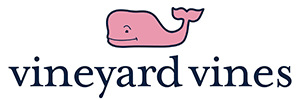 Vineyard Vines logo – A stylized pink whale and company name in blue against a white background. Vineyard Vines is a lifestyle brand known for its vibrant and preppy apparel. Offering a range of clothing, accessories, and more, Vineyard Vines captures the essence of relaxed elegance and embodies the joy of coastal living.