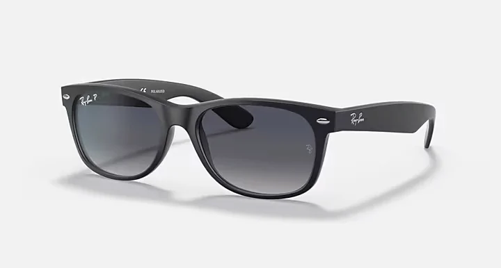 Matte black Ray-Ban Wayfarer sunglasses with polarized gray gradient lenses, ideal for protecting your eyes during beach activities in Panama City Beach.