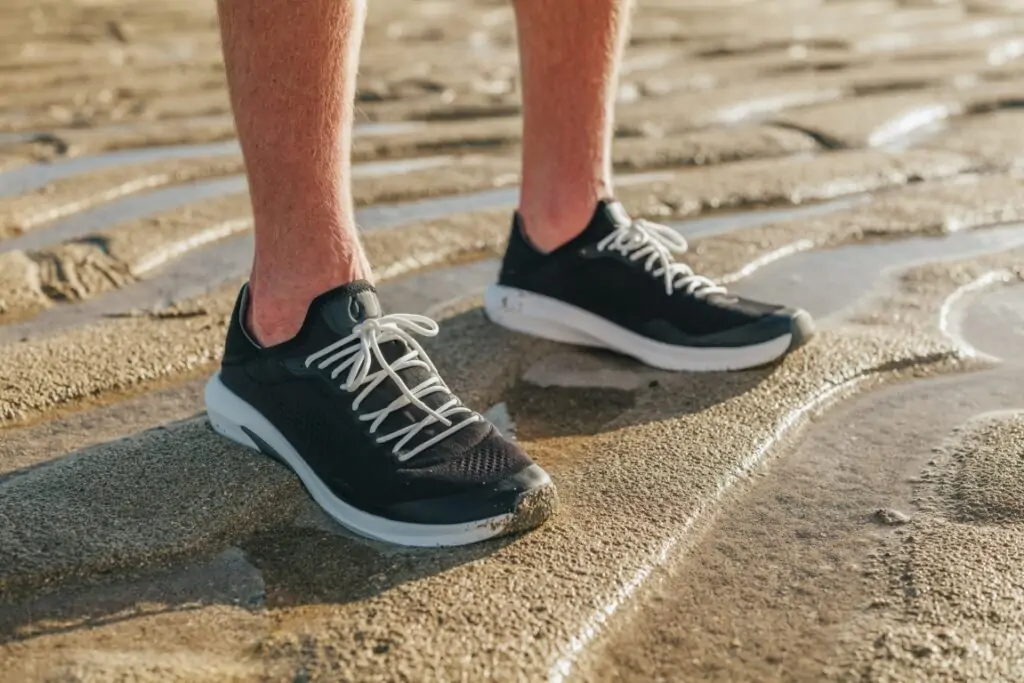 Black OluKai sneakers providing comfort and support, ideal for beach walks in Panama City Beach.