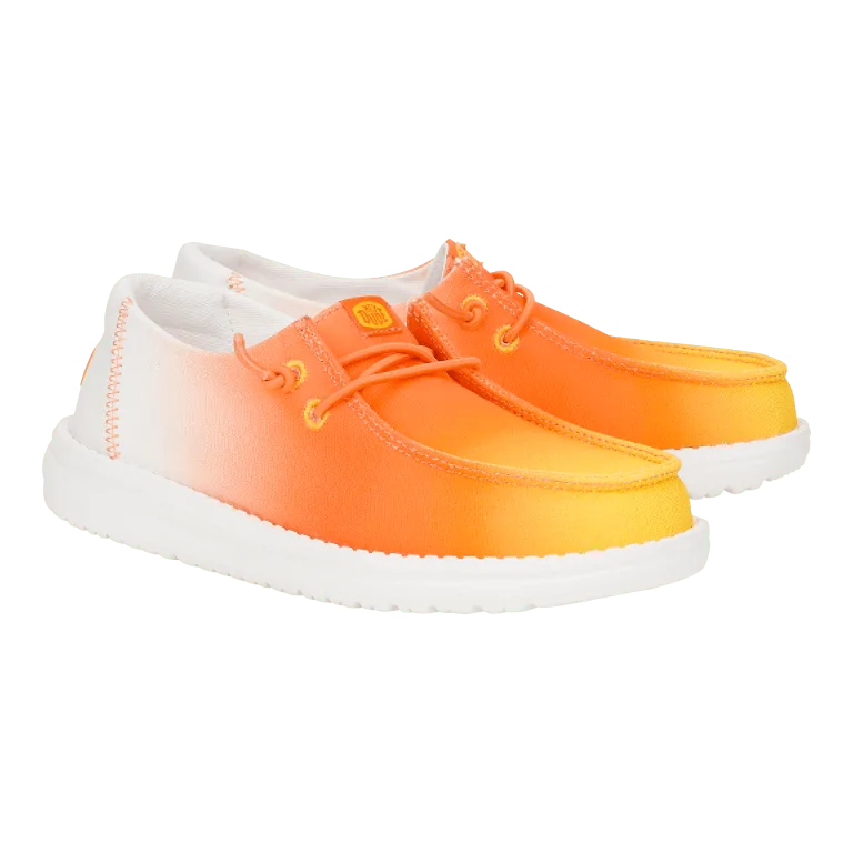 Bright orange HEYDUDE slip-ons, offering bold style for beach days in 30A.