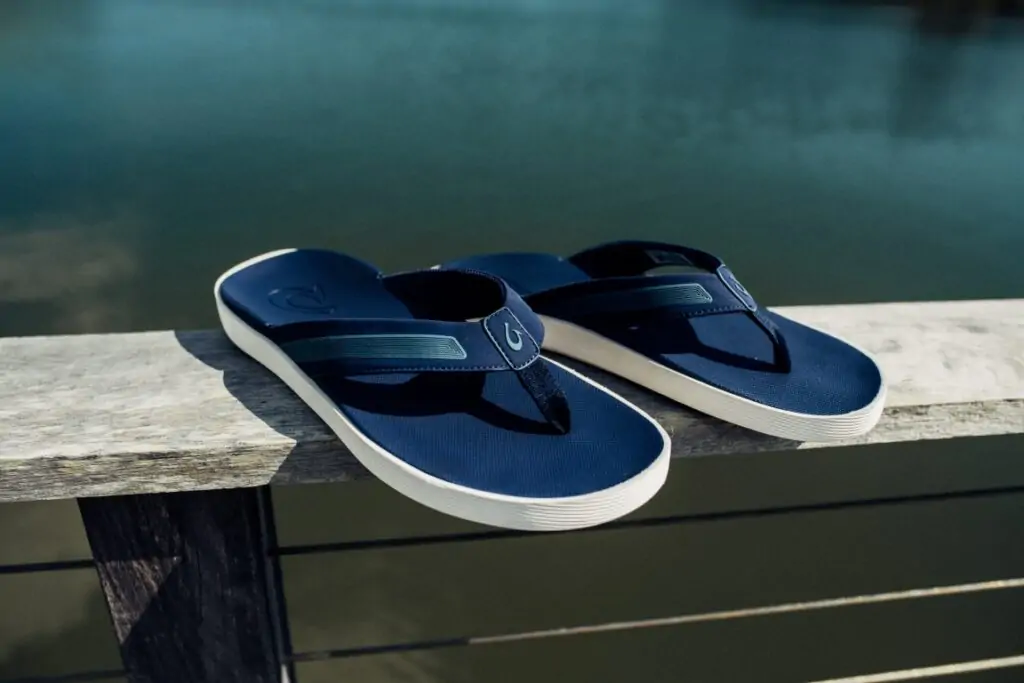 OluKai navy slip-on shoes, ideal for boating and beach trips in Destin.