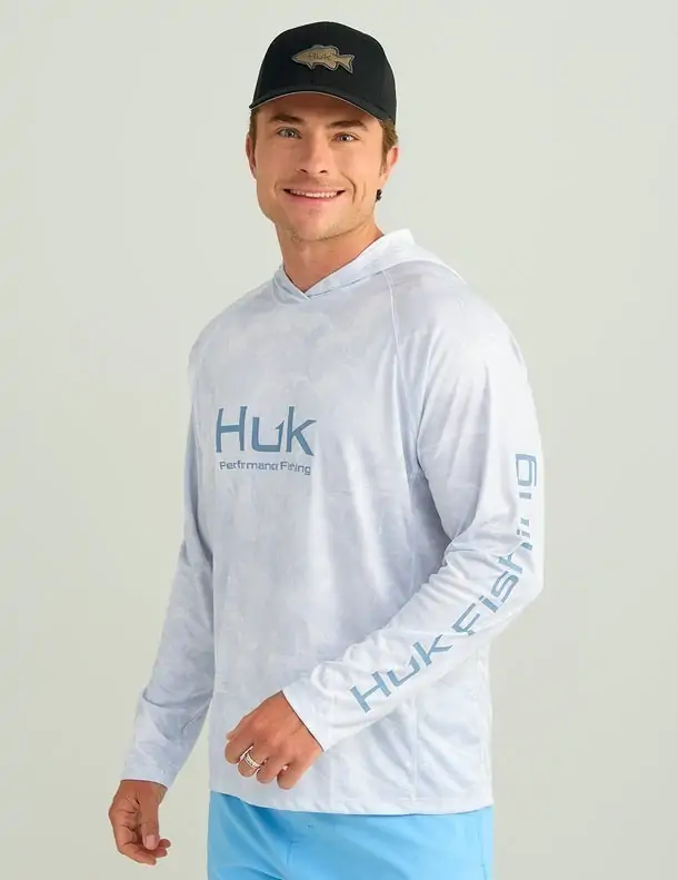 Men's gray Huk hoodie, designed for warmth and comfort during early morning fishing trips in Panama City Beach.