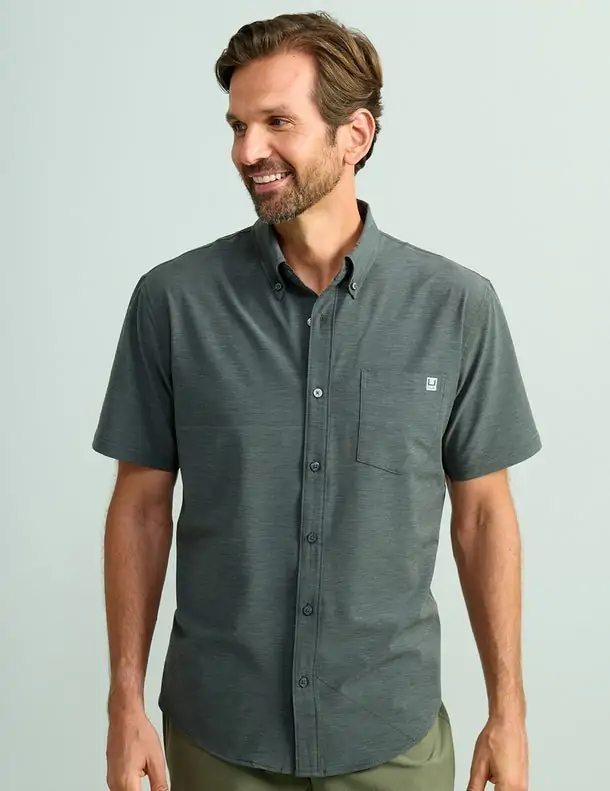 Men's short-sleeve Huk button-up shirt, offering moisture-wicking comfort for fishing trips in Panama City Beach.