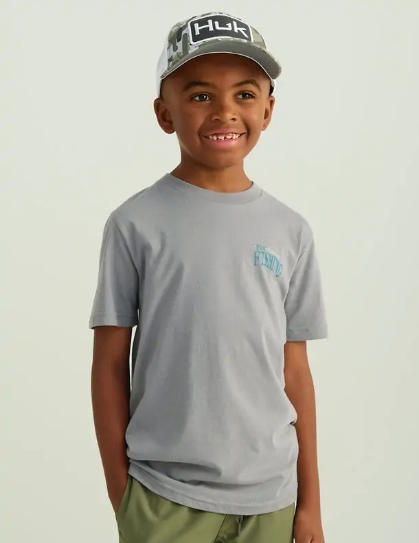 Boy wearing a gray Huk t-shirt, perfect for beach and fishing activities in Panama City Beach.