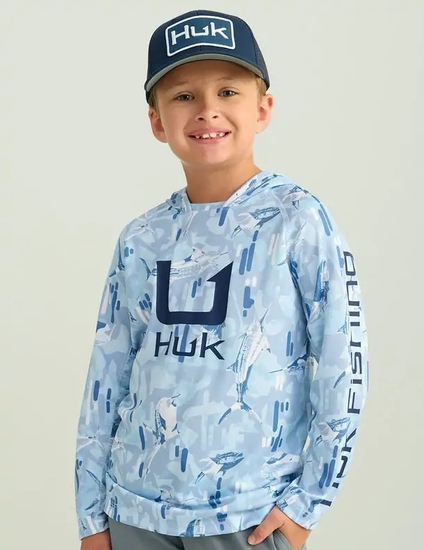 Boy wearing a blue camo Huk fishing shirt, ideal for outdoor adventures in Destin.