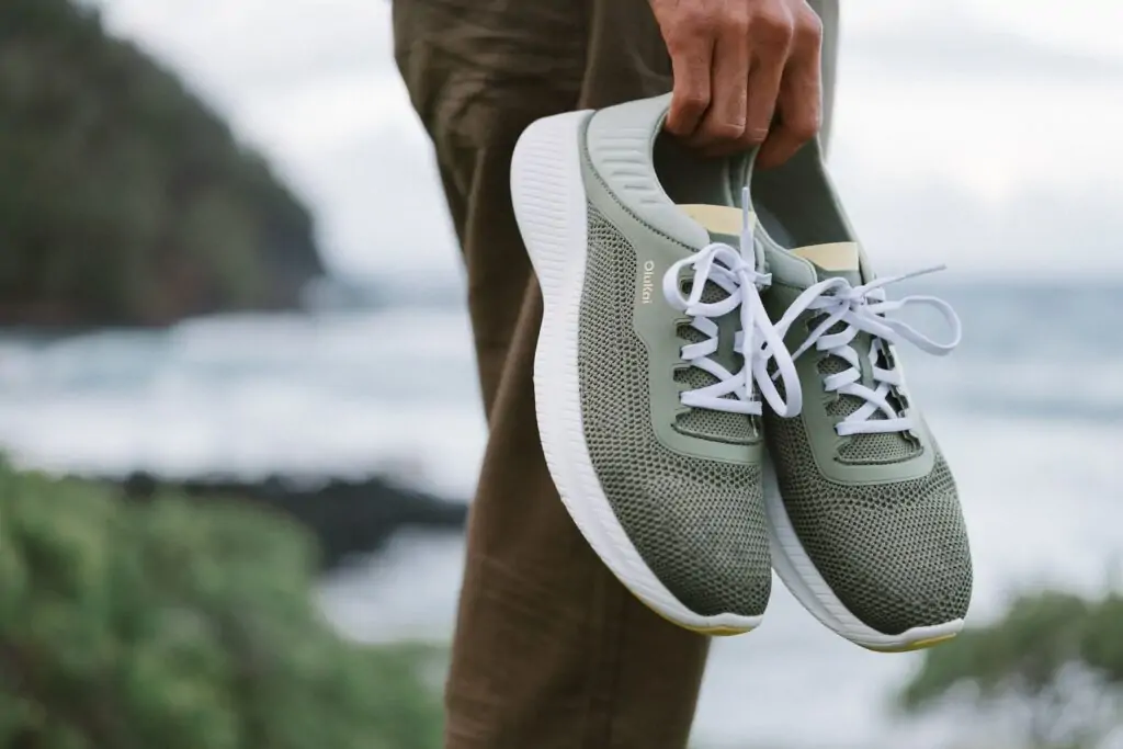 Men's OluKai lightweight green sneakers, perfect for exploring coastal trails in Panama City Beach.