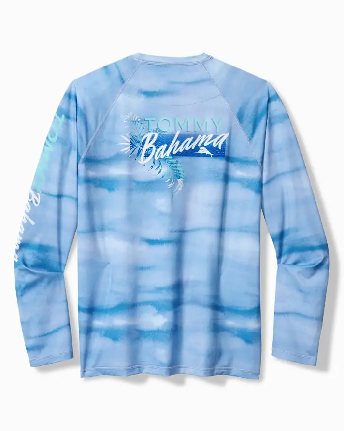 Tie-dye blue Tommy Bahama long-sleeve shirt with "Tommy Bahama" lettering and palm graphics, great for sun protection during Panama City Beach fishing trips.
