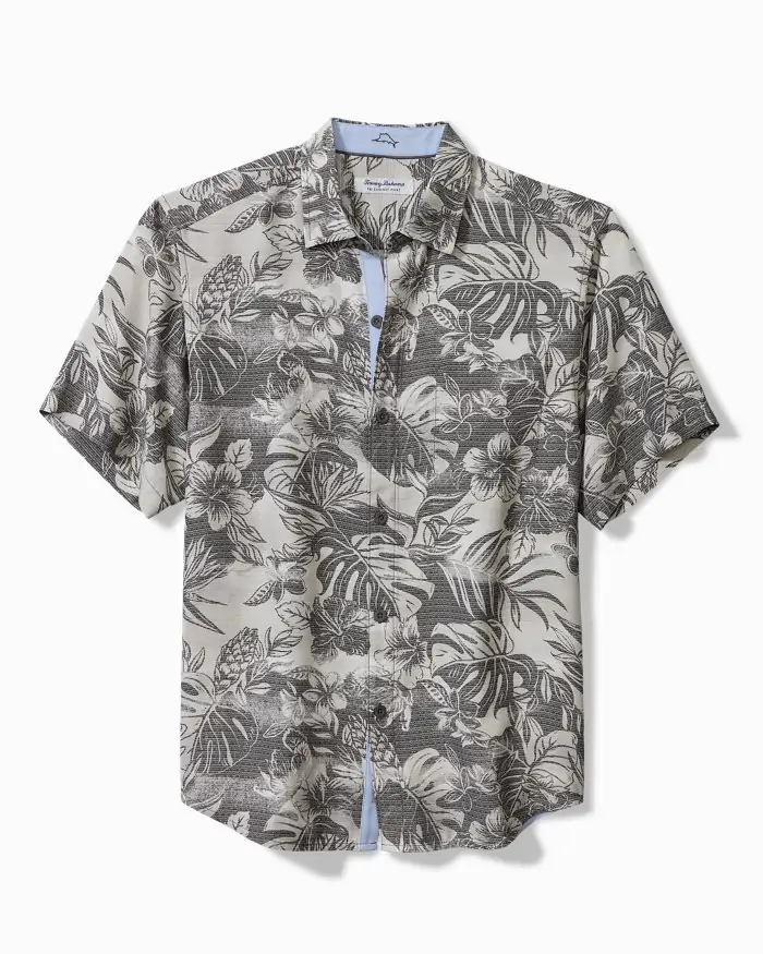 Monochrome floral and palm-patterned Tommy Bahama short-sleeve button-up shirt in neutral tones, blending comfort and style for 30A boutique shopping or Grayton Beach art festivals.