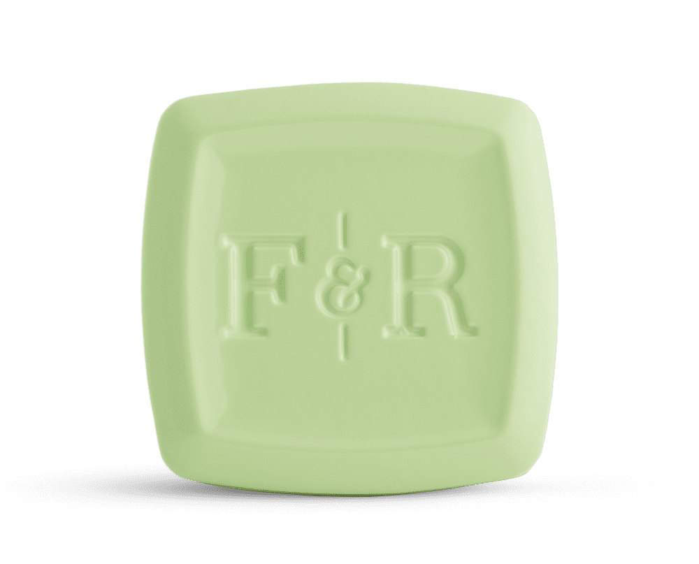A refreshing green solid cologne bar with a subtle matte finish and the Fulton & Roark logo, inspired by the natural beauty of the 30A area, making it a great companion for outdoor enthusiasts.