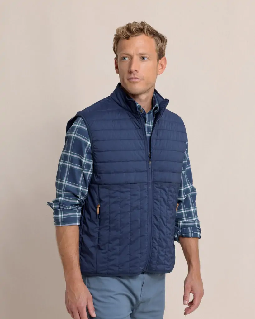 Men's blue quilted Southern Tide vest, offering warmth and lightweight comfort for cool days in Destin.