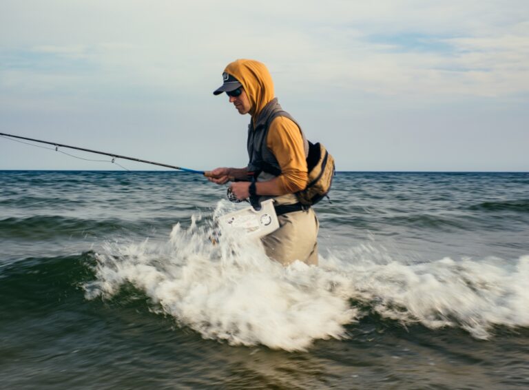 Man fishing in the ocean wearing FreeFly gear, designed for comfort and performance in the coastal waters of Panama City Beach.