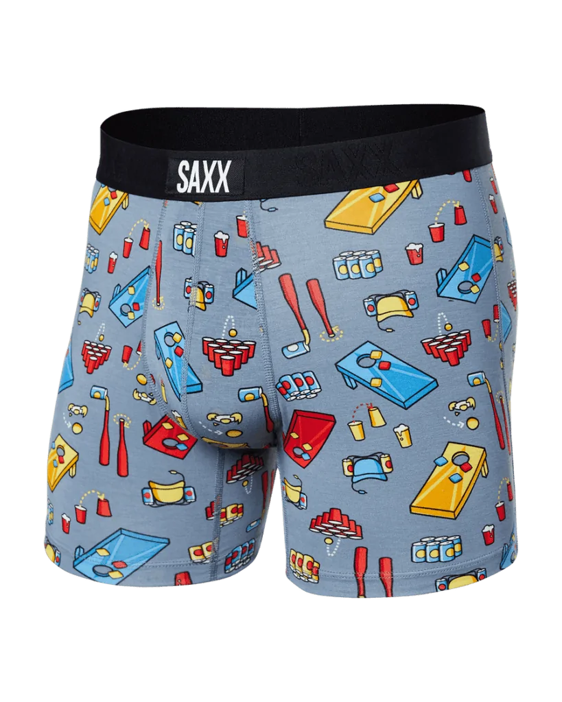 SAXX boxer briefs in a light blue color with cornhole and beer pong illustrations, designed for laid-back days and games with friends in Destin or Miramar Beach.