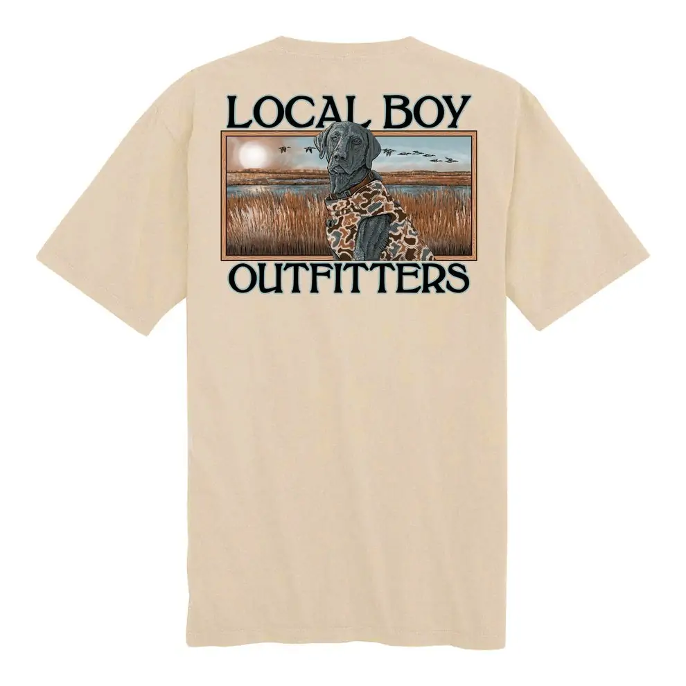 Beige short-sleeve shirt with a detailed marsh dog graphic by Local Boy Outfitters, reflecting the outdoor lifestyle of the Florida Panhandle.